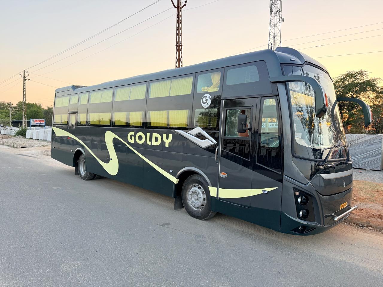 Goldy bus from a front-side angle on the road