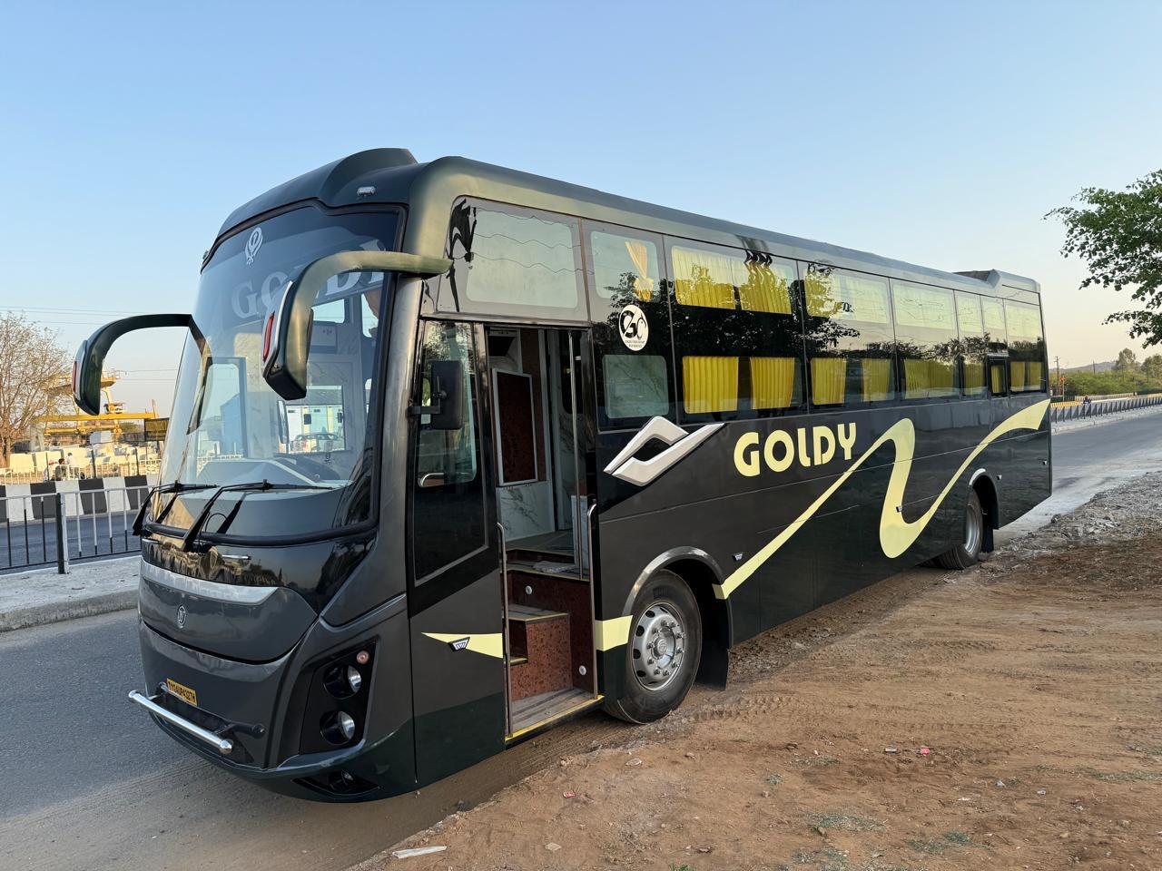 Goldy bus parked on the road during daylight